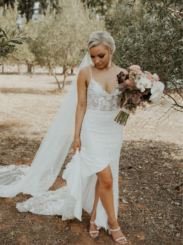Schlichtes langes Brautkleid mit Spaghettiträgern und seitlichem Schlitz aus Tüll.DB10780