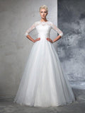 Robe de mariée longue en organza à manches trois-quarts avec applications de joyaux en forme de robe de bal