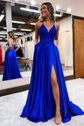Vestido de gala largo y elegante en línea A con tirantes al cuello, satinado, abertura frontal, espalda descubierta y bolsillos