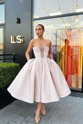 Vestido de fiesta corto sin tirantes tipo línea A con bolsillos